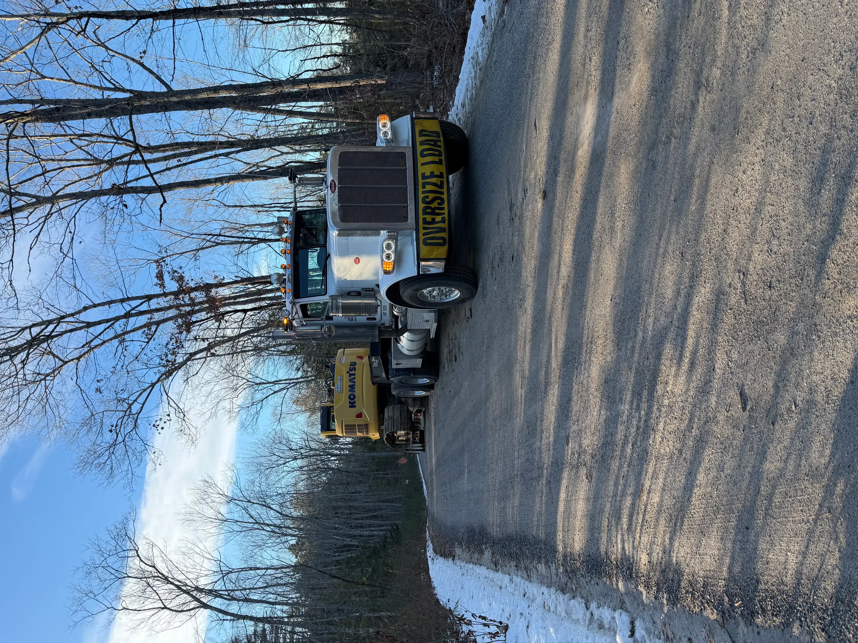 Snow plow truck with spreader on winter road, equipped for snow and ice removal