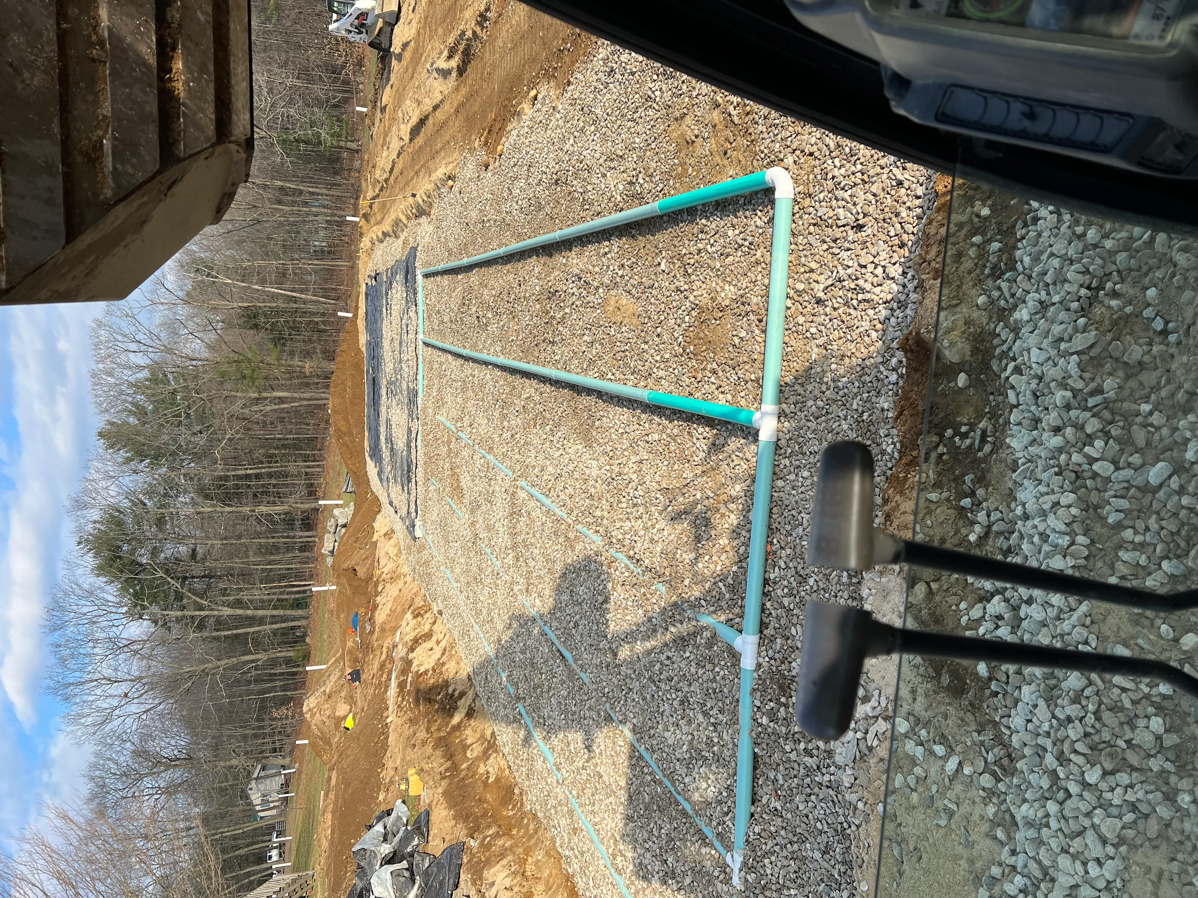 Gravel driveway with crushed stone base and drainage marking lines